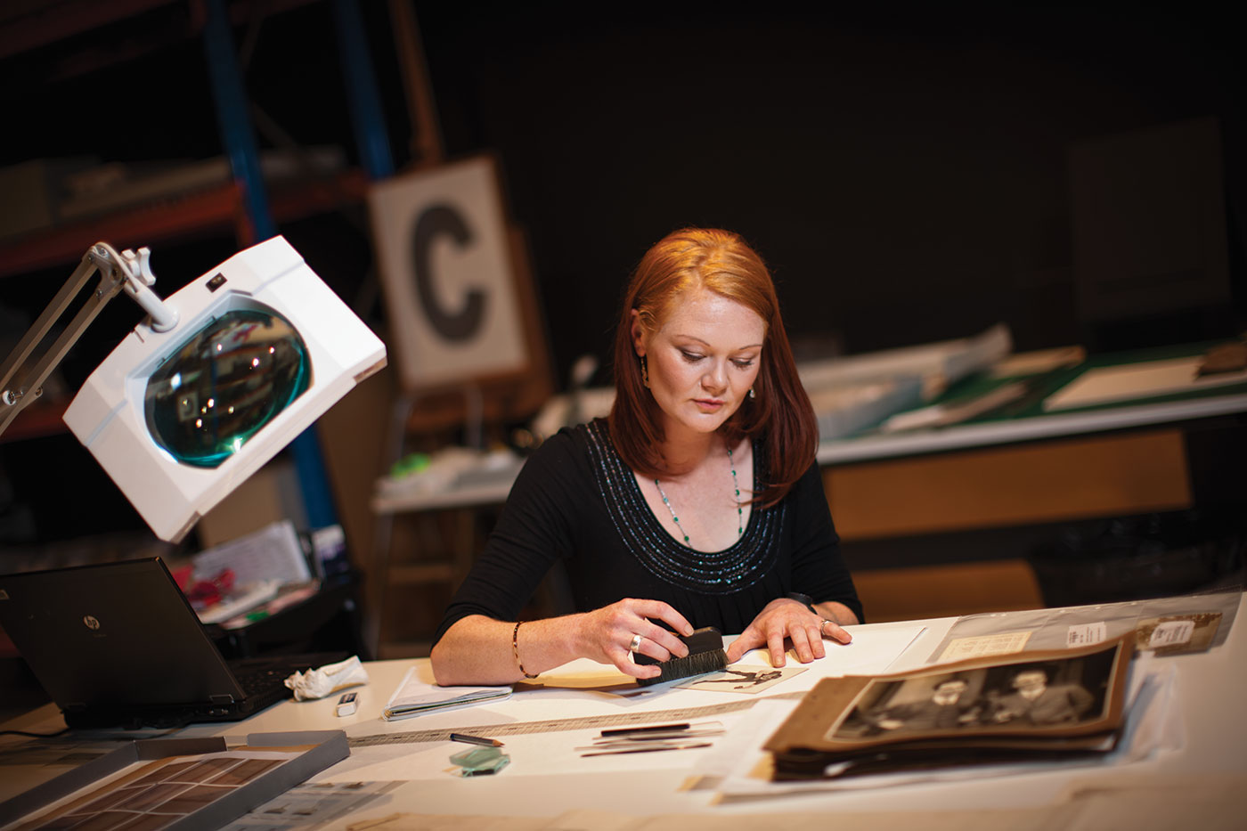 Conservator Jess Wignell at work during the Museum Workshop exhibition.