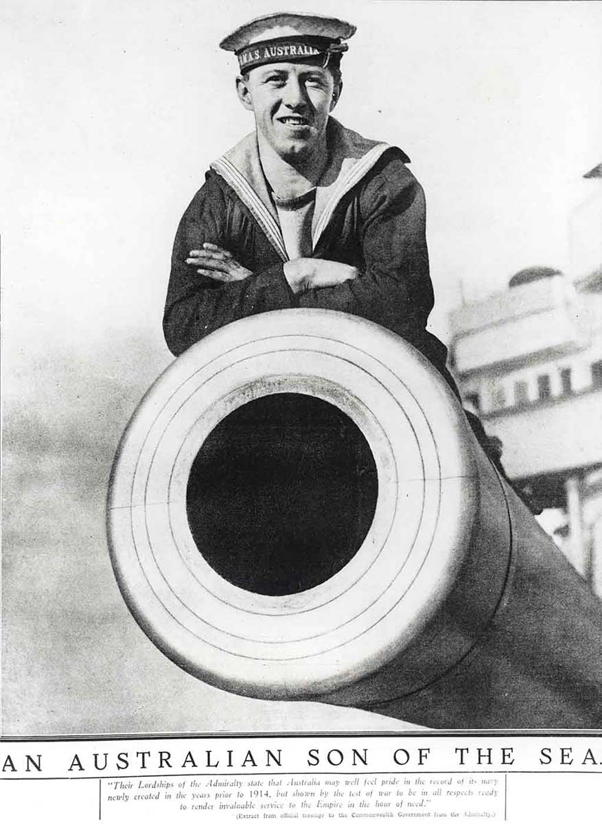 A sailor of the HMAS Australia poses on top of the battle-cruisers mighty guns.