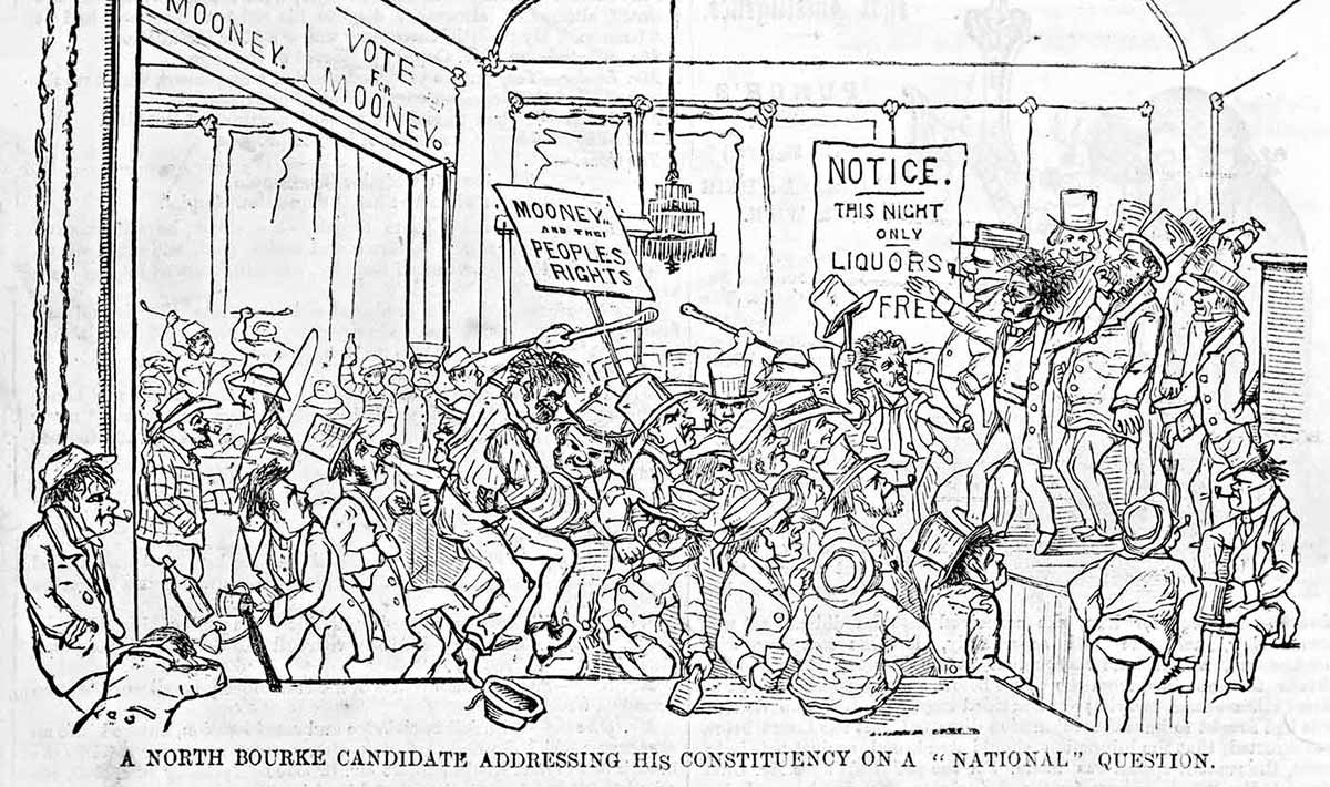 Cartoon depicting the interior of pub in which dozens of men are brawling before a group of men on a stage. The caption reads: ‘A North Bourke candidate addressing his constituency on a “national” question’.