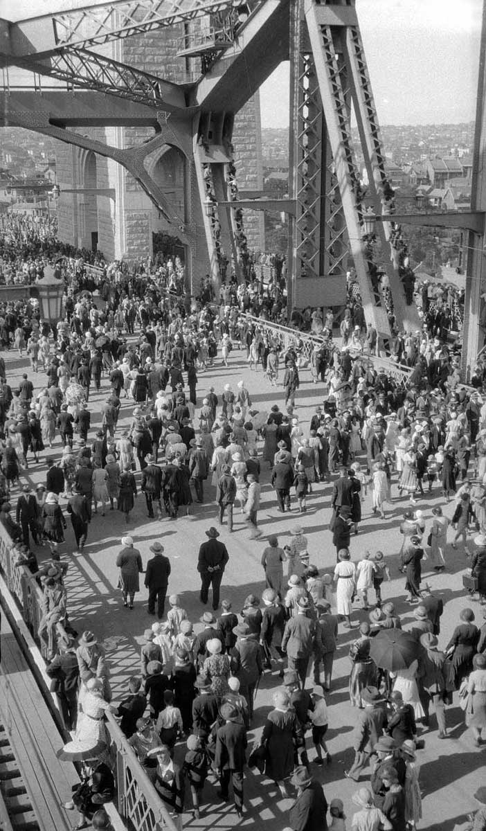 High shot showing hundreds of people crossing the road deck. - click to view larger image