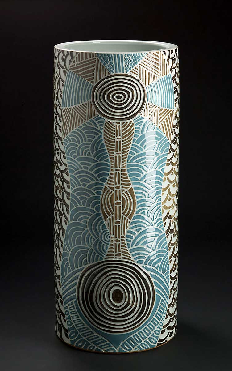 Cylindrical pot with blue and brown circular patterns on the exterior. - click to view larger image