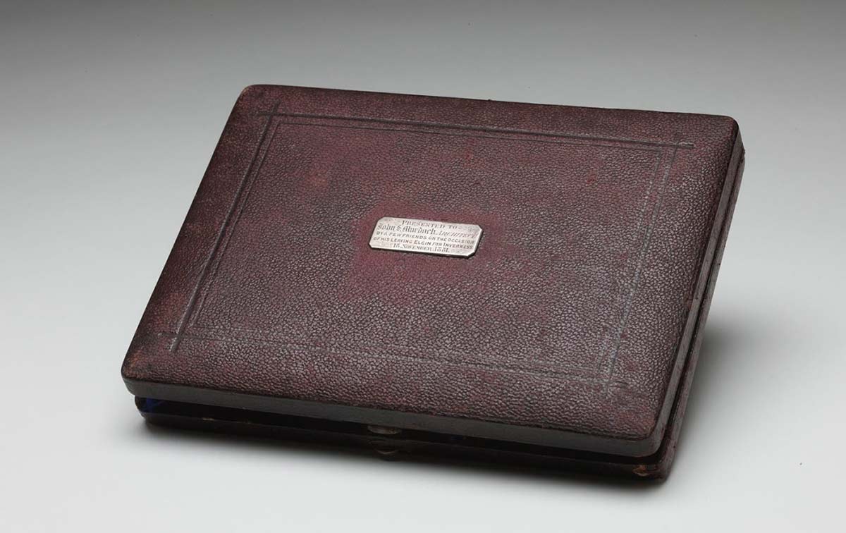 A brown, leather covered case for drawing instruments.