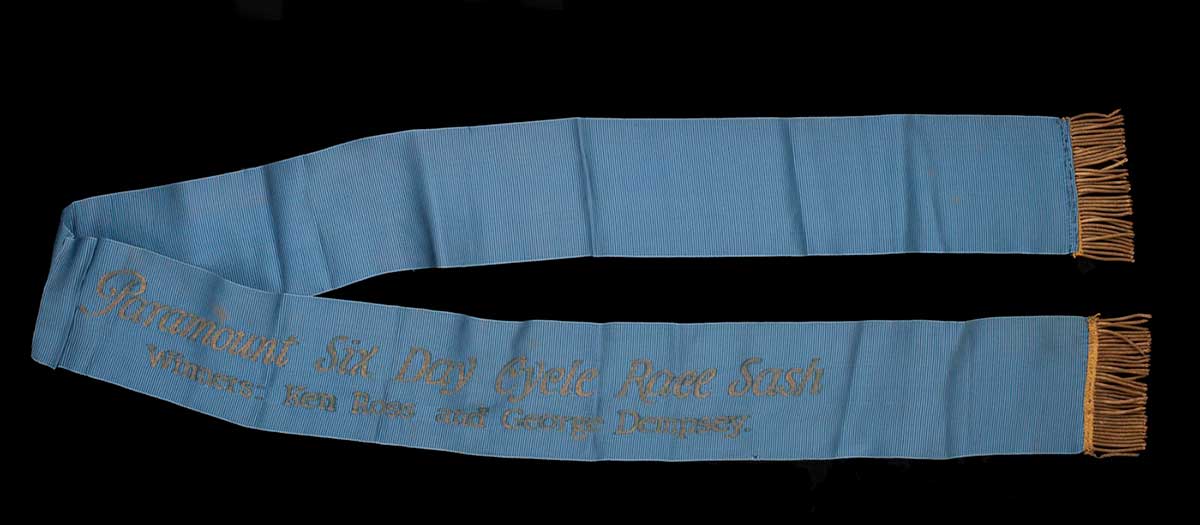 Mid blue sash with gold fringing and gold lettering. - click to view larger image