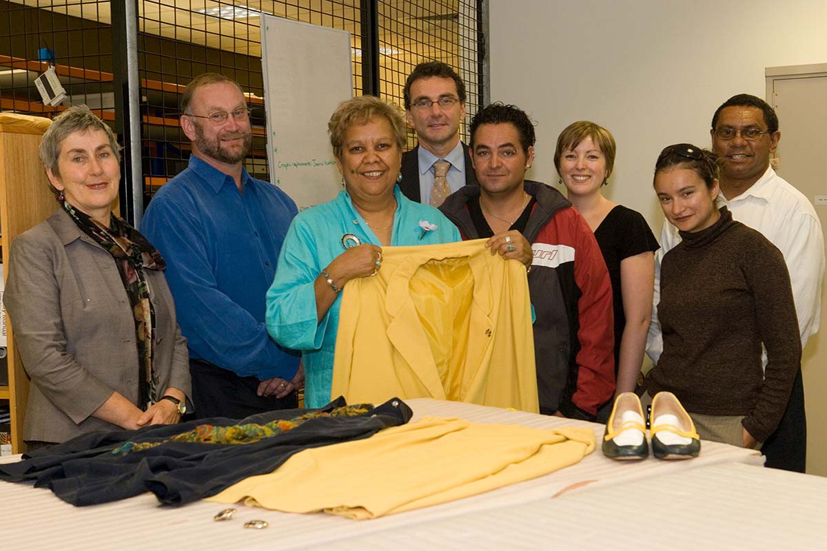 Museum staff and Jackie Huggins with her jacket, blouse, shoes and earrings.