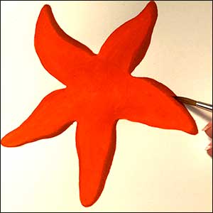 a vibrant illustration of an orange coloured starfish with dark blue outline