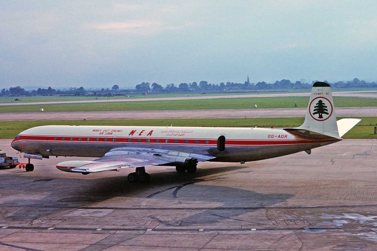 A jetliner with its distinctive rectangular windows on the tarmac at an airport.