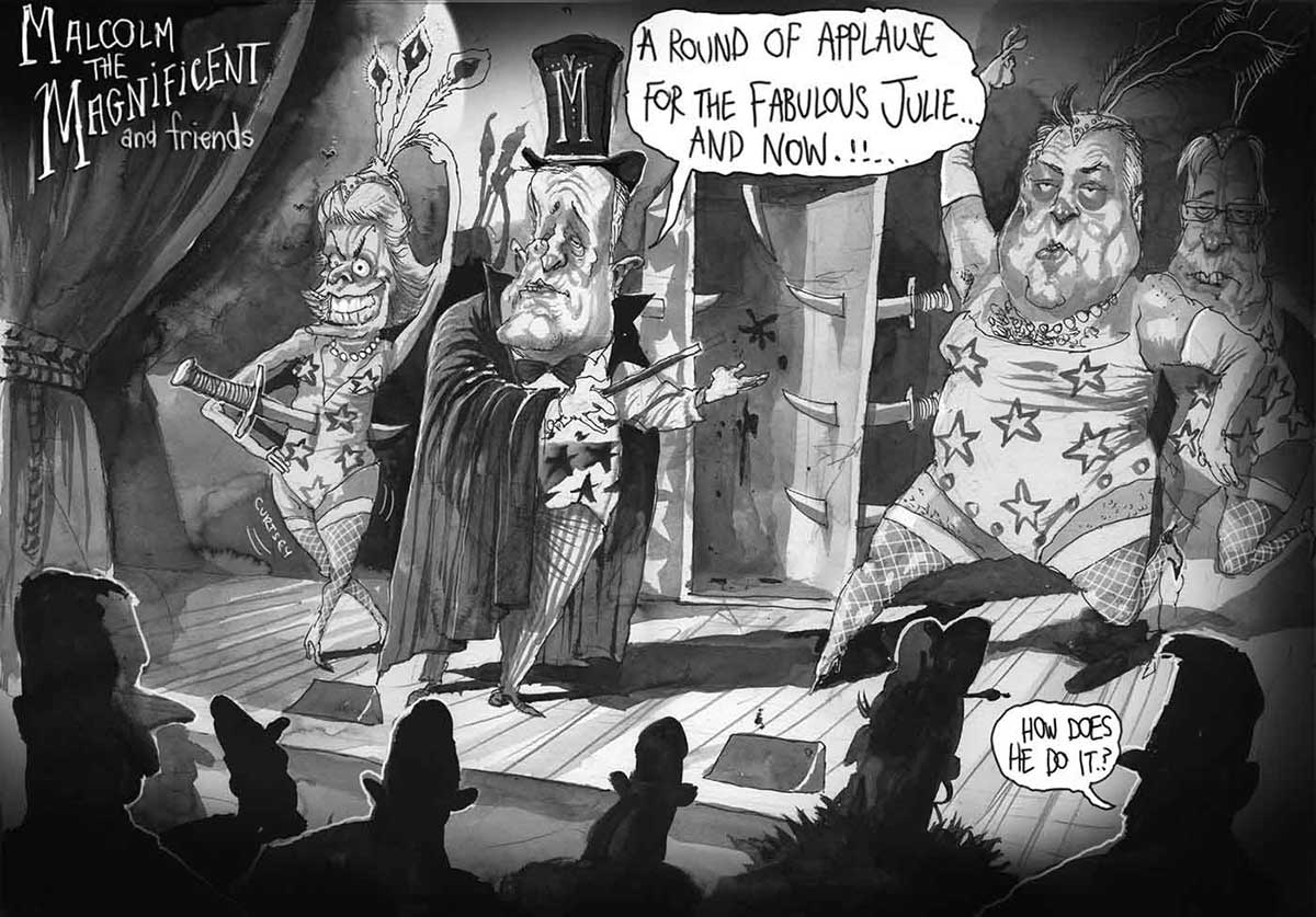 A black and white scene reminiscent of a magic act in a vaudeville show titled 'Malcolm the Magnificent and friends'. Four characters are on the stage facing an audience. Malcolm Turnbull is centre stage dressed in a top hat with a giant 'M', a magician's cape, a vest with stars and striped pants. He holds a wand in one hand and gestures to a human sized disappearing act box saying 'A round of applause for the fabulous Julie ... And ... now !!' The door is open and daggers pierce both sides. On the left of the cartoon is a grotesque female figure, representing Julie Bishop, dressed in a show girl costume including fishnets and a feather tiara. She has one hand above her head, the other on her hip. She has an enormous dagger running through her belly and sticking out her back. The third character, on the right, is a very chubby Joe Hockey, dressed in swimsuit drag with fishnet stockings, necklace and tiara. One long-gloved arm is thrown up above his head, the other held akimbo. A fourth charcter is behind Joe Hockey. At the front of the cartoon the back of the heads of the front row of the audience is in silhouette with one person saying 'How does he do it?' - click to view larger image