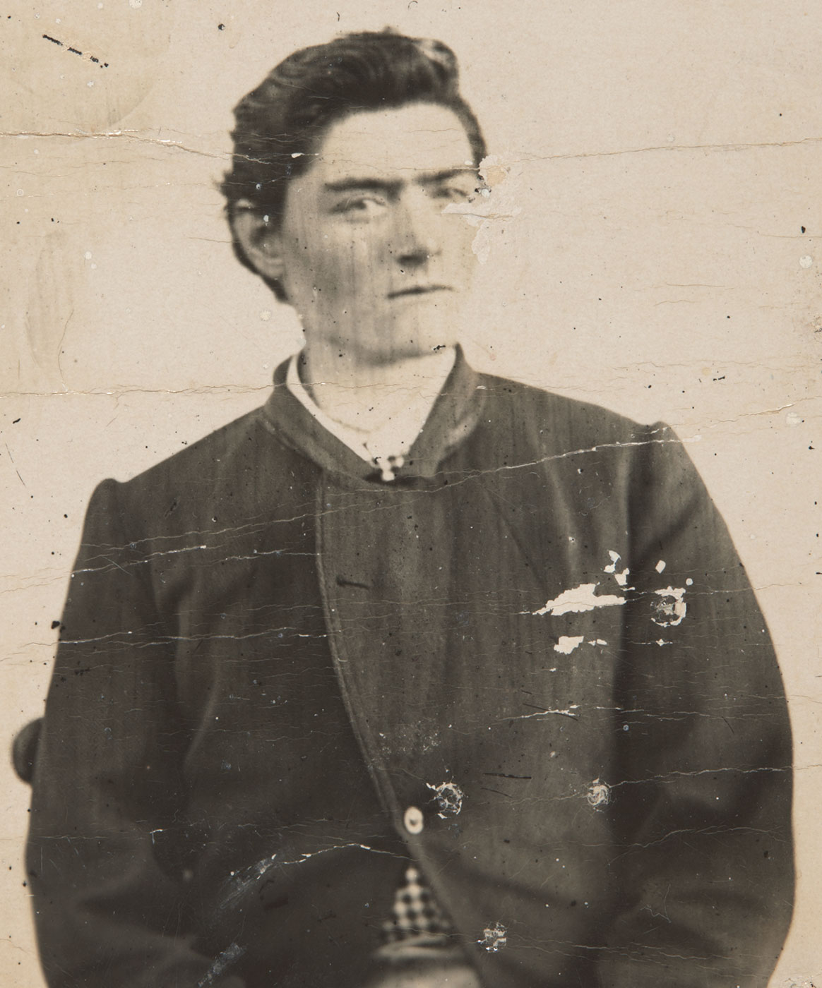 Black and white photo of a young man with dark hair and wearing 19th Century clothing. - click to view larger image