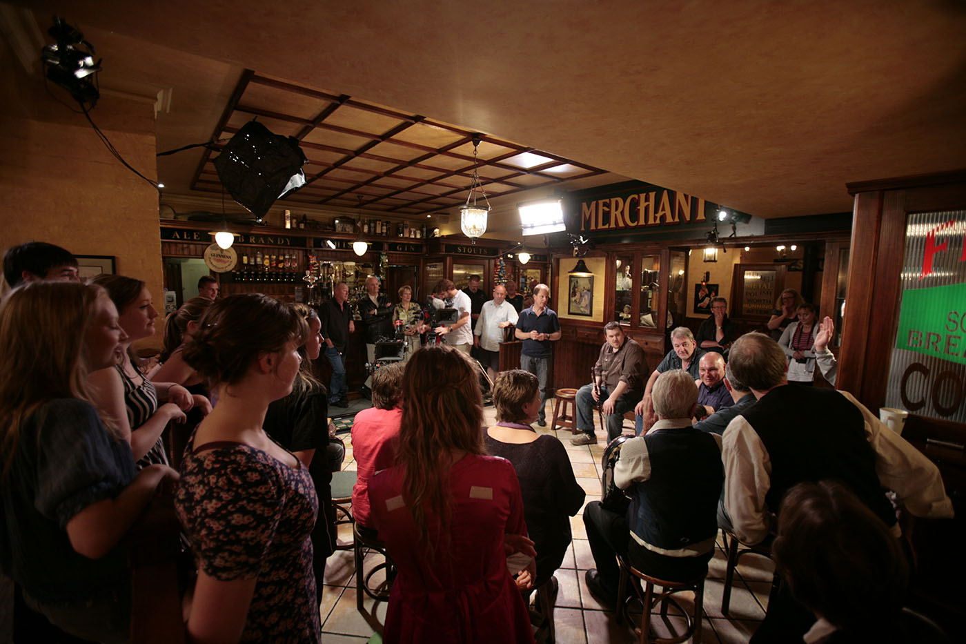 Musicians, Irish dancers and film crew on set in a pub. - click to view larger image