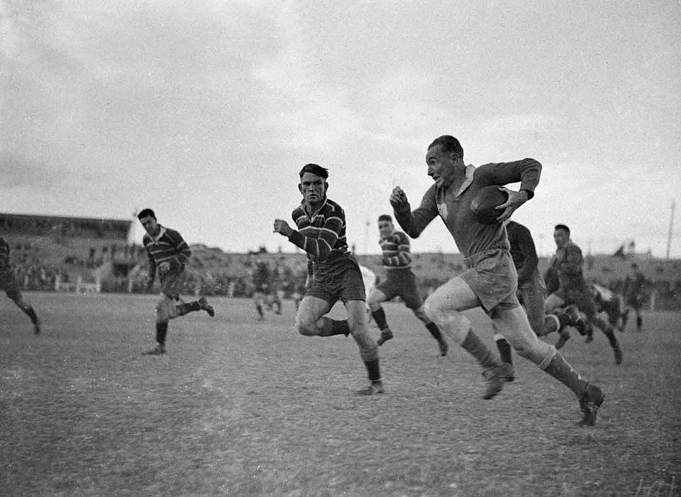 Rugby league players running on the field