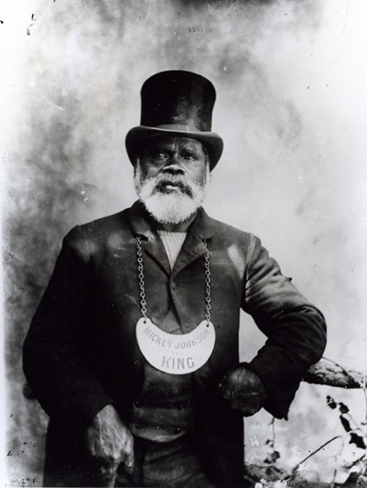 Black and white photograph of a man wearing a breastplate. - click to view larger image