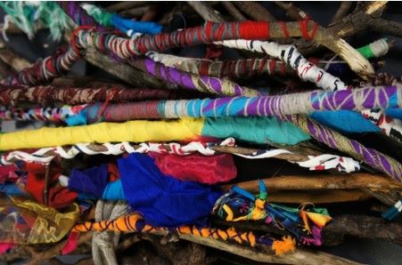 An image of sticks wrapped in brightly coloured string.