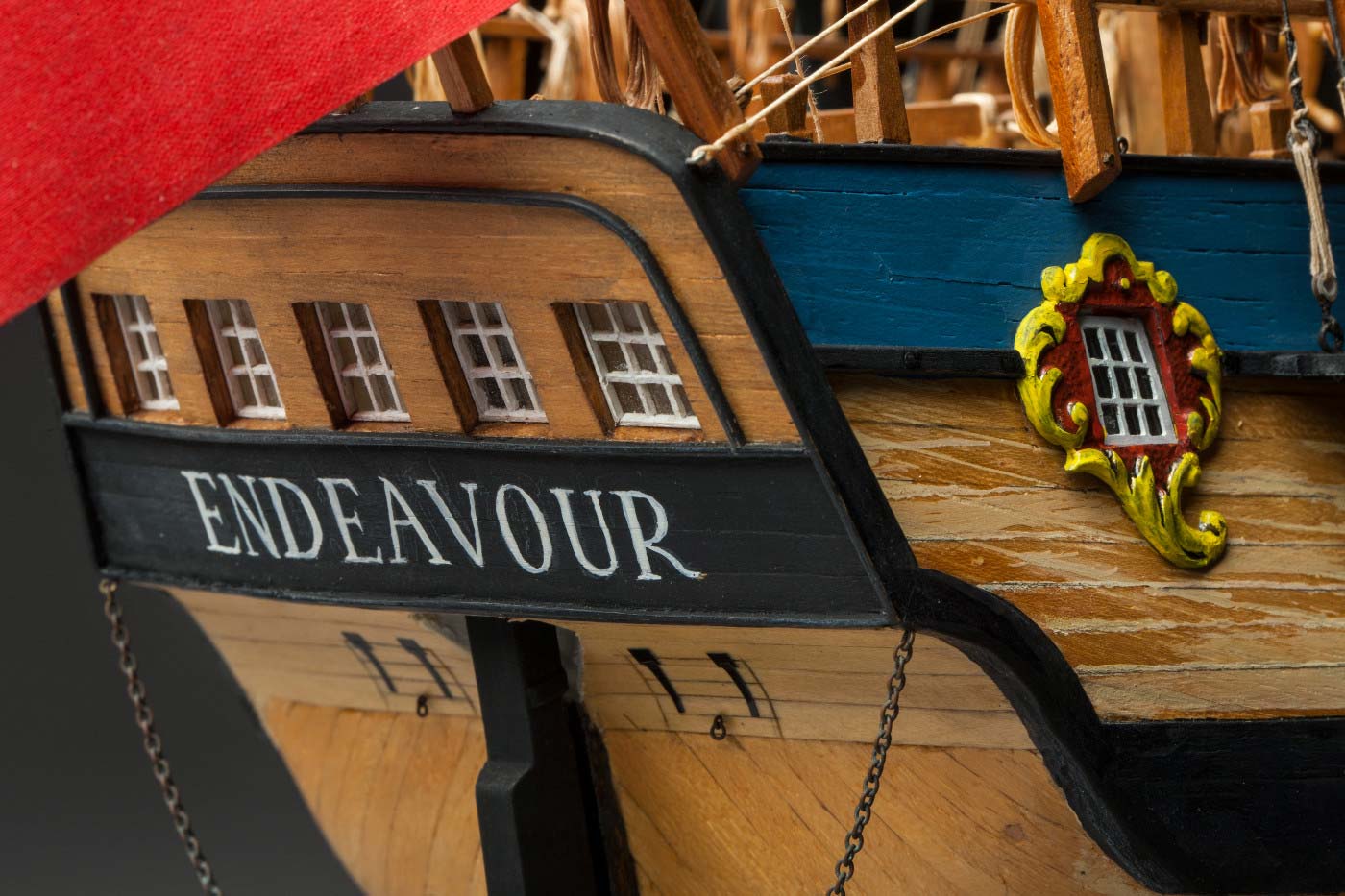 Detail image showing the back of a model wooden sailing ship. 'Endeavour' is painted under a series of five windows. - click to view larger image