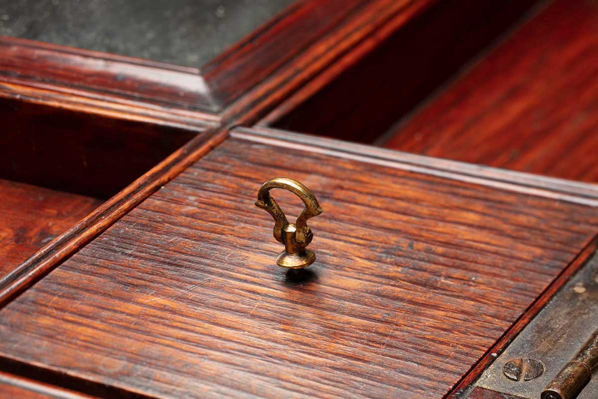 Detail of a wooden dresser table with multiple compartments. - click to view larger image