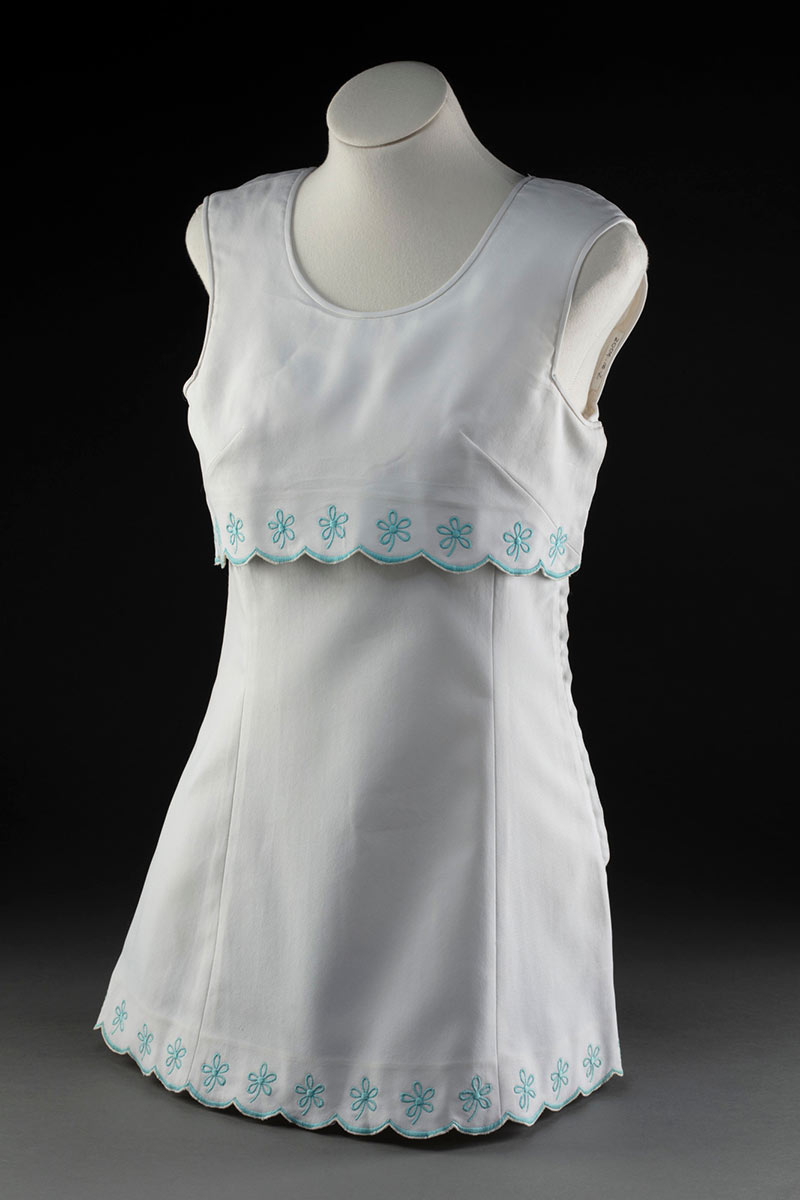 White tennis dress with pale blue trim, on a mannequin.  - click to view larger image