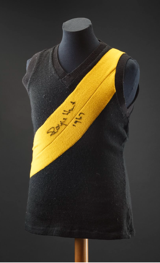 A sleeveless football jersey, black with a golden strip across the chest. - click to view larger image
