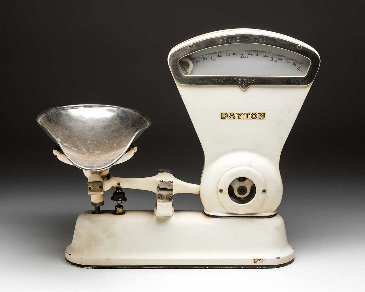A set of metal scales, painted white, with a 'DAYTON' brand name printed on the upright section, and with a seperate stainless steel scoop. - click to view larger image