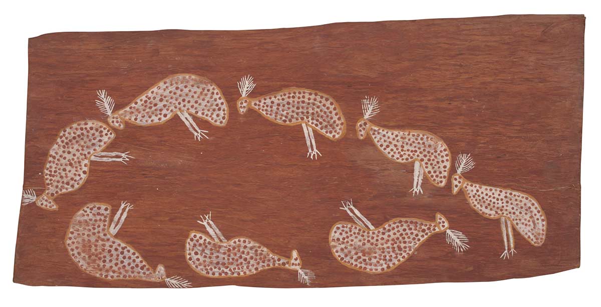 A bark painting worked with ochres on bark. It depicts eight small birds each following each other, arranged in an off-centre oval-shaped ring. The birds are painted white with yellow outlines. They have white crests on their heads and red dots decorating their bodies. The painting has a red background. - click to view larger image