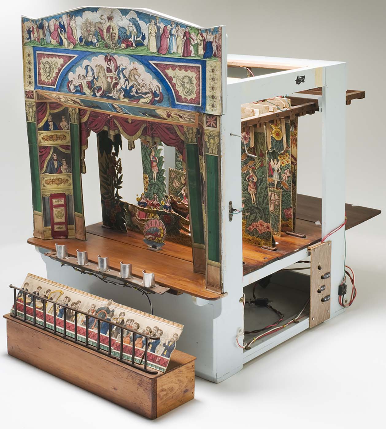A photograph of a theatre set for Cinderella. The photograph is taken to show the toys mechanics and intricate sets. - click to view larger image