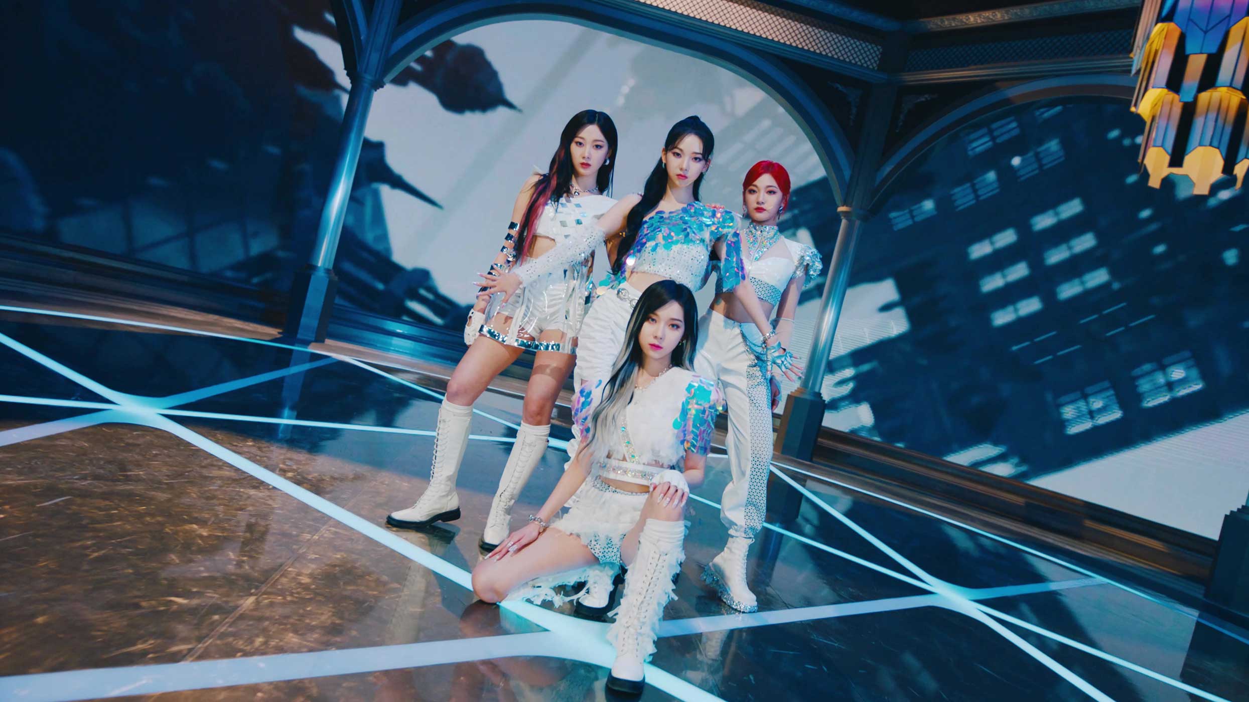 Four band posing wearing blue and white costumes on a futuristic blue backdrop.