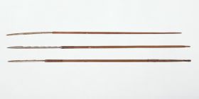 Three short arrows made of fir wood, and a bone point with barbs cut out on one side. The shaft ends are wrapped with cherry bark strips and split feather quills.