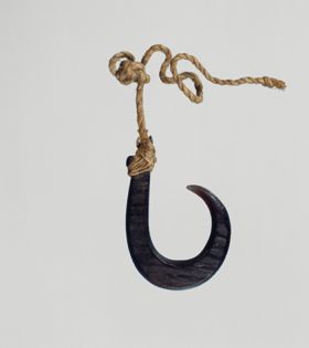 Fishhook made of large dark purple pinna marina shell, where strings made of various plant fibres are attached.