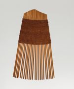 A comb made of twenty-five small sticks held together by a weave of light brown fibres.