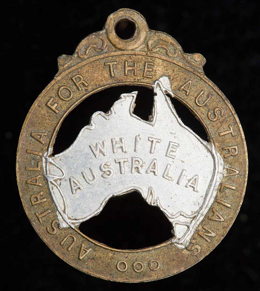 This 28mm-high badge has the words ‘Australia for the Australians’ stamped on the rim and the words ‘White Australia’ stamped on silver-painted representation of the Australian continent in the middle. - click to view larger image