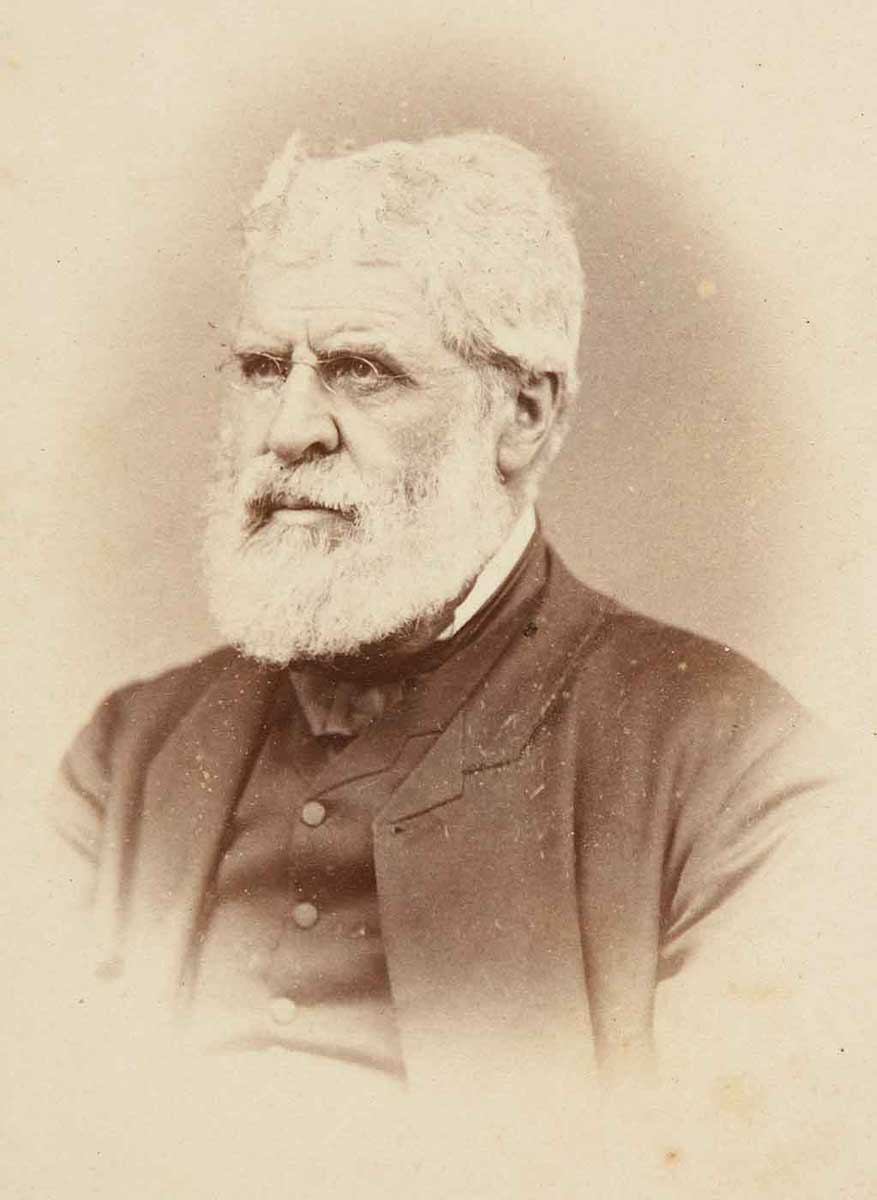 Daguerreotype of white-haired, bearded man in dark suit. - click to view larger image