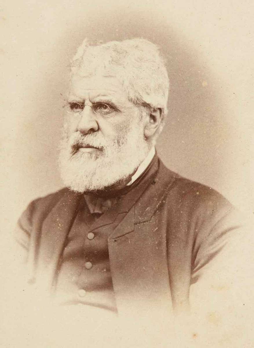Daguerreotype of white-haired, bearded man in dark suit. - click to view larger image