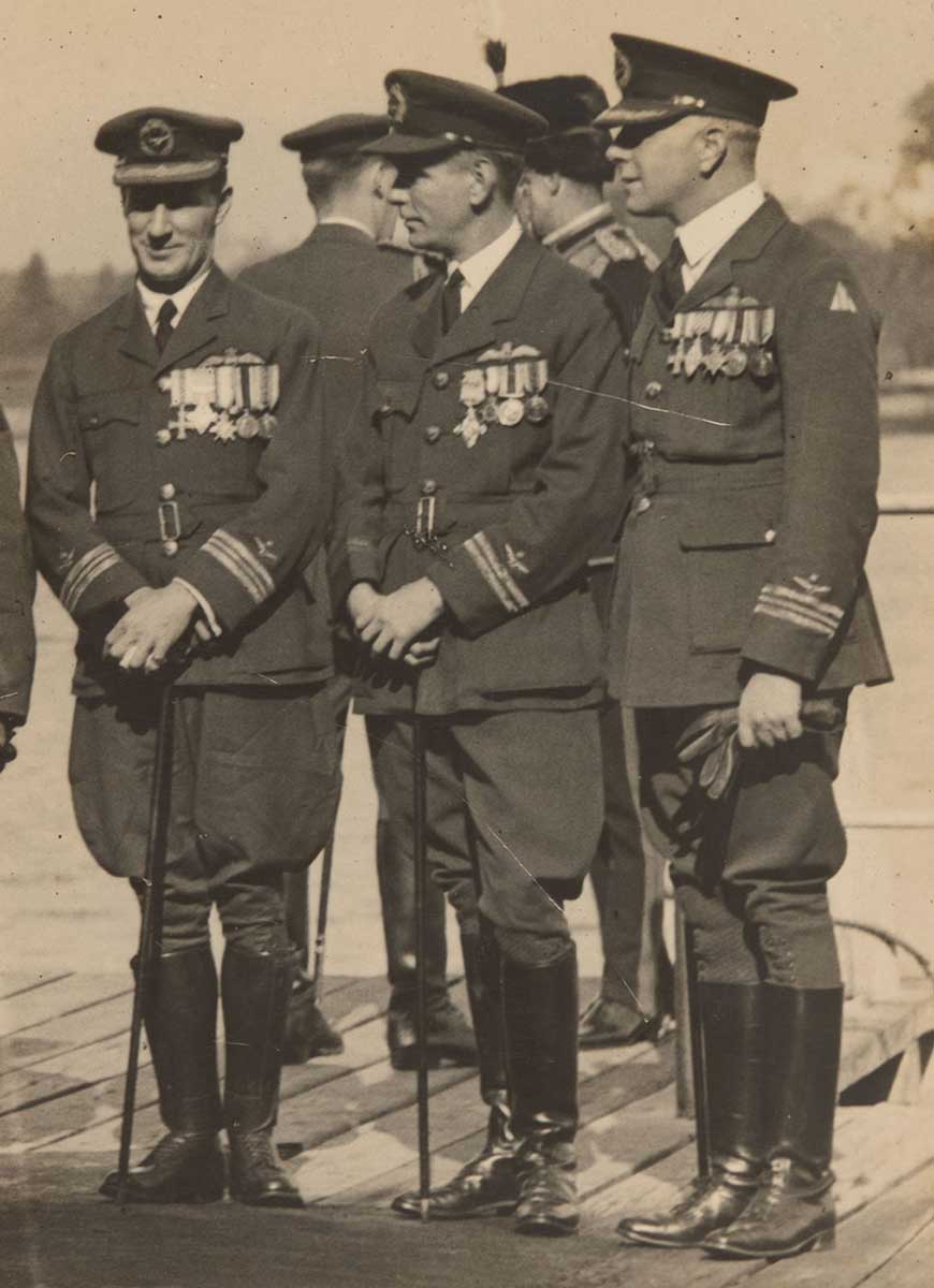 A black and white photo of Kingsford Smith in full RAAF uniforms with canes.
