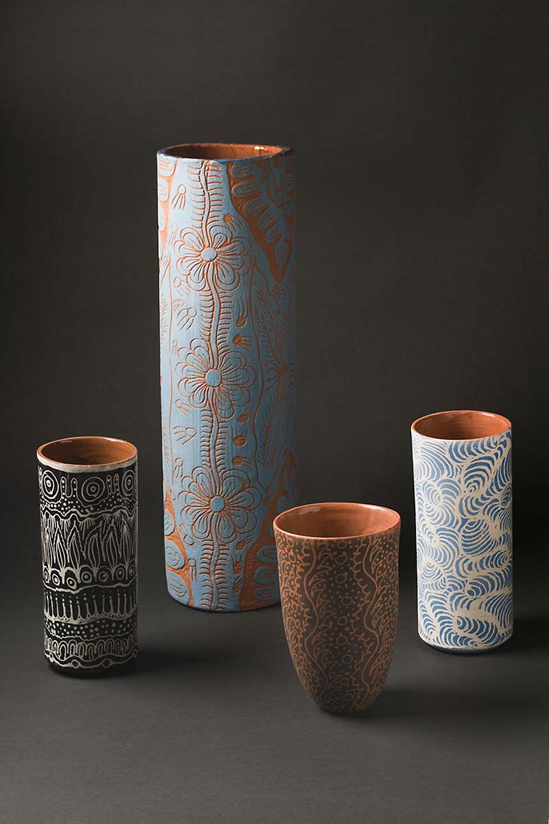 Four cylindrical vases in shades of brown and blue. - click to view larger image