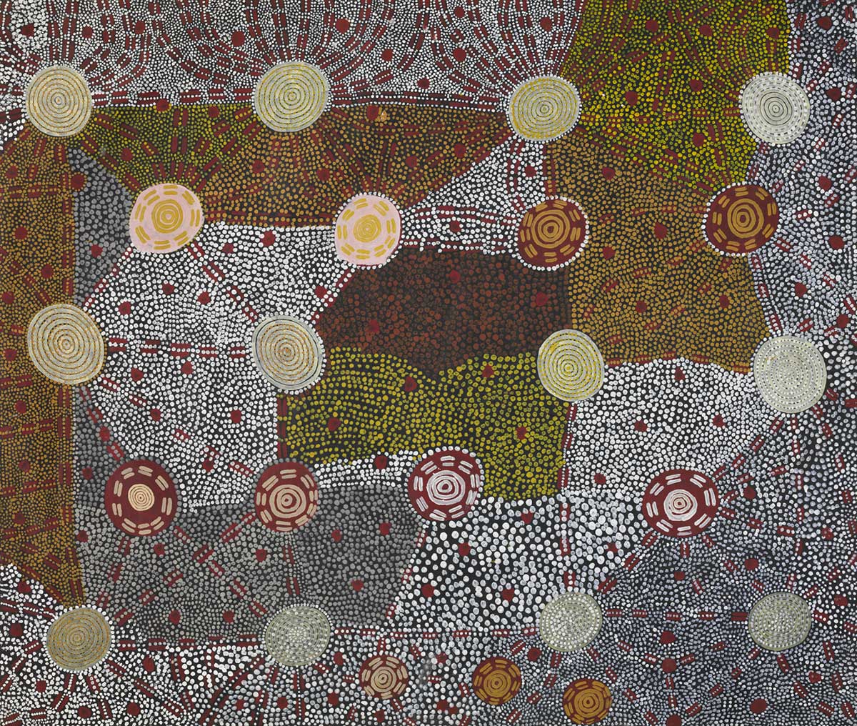 A painting depicting numerous circles, some fully concentric and others partially concentric with fragmented lines around circumference. Linked with brown fragmented parallel lines. Background black with large brown spots, and dots in patches of white, yellow, brown and green.