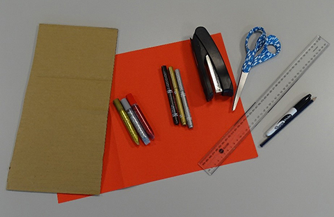 Coloured paper, stapler, scissors, pens and ruler