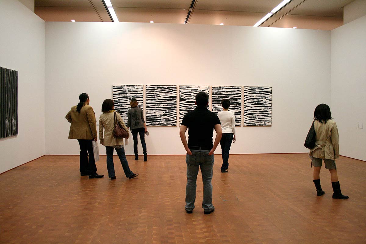 People walking around in an exhibition space. - click to view larger image