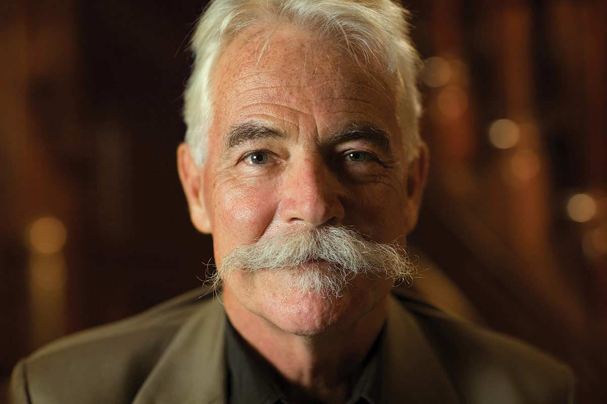 Studio portrait photograph of Emeritus Professor Alan Mackay-Sim AM.