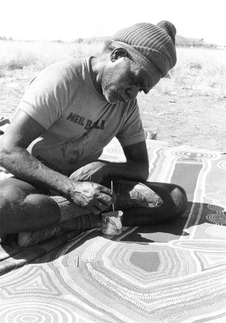 Portrait photo of an Aboriginal Australian man painting. - click to view larger image