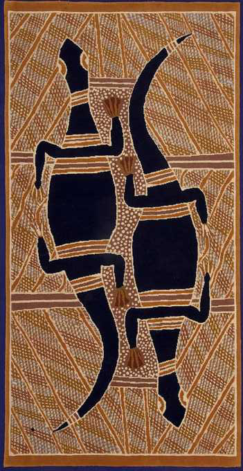 A carpet featuring an Australian Indigenous design. The carpet is tall and narrow. The design depicts what appear to be two goannas, next to each other but facing opposite directions. The goannas are black with red and yellow bands across them. Between them is an area of red with a traditional white dot pattern. The remainder of the print is covered in traditional line patterns, in yellows, reds and ochres.