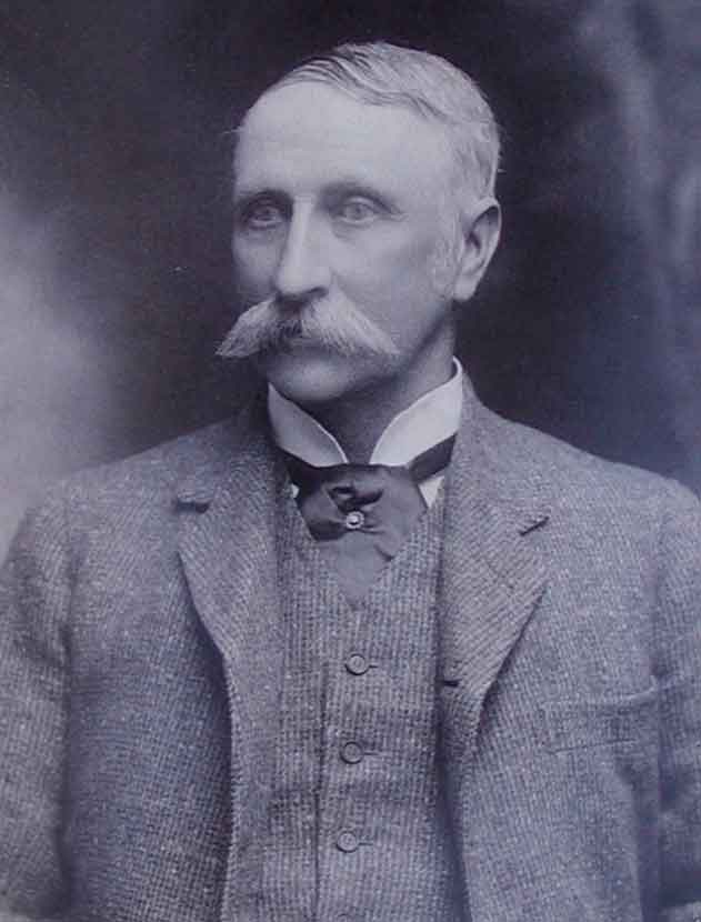 Black and white photo portrait with a blue sepia tone of a man in 19th Century attire. - click to view larger image