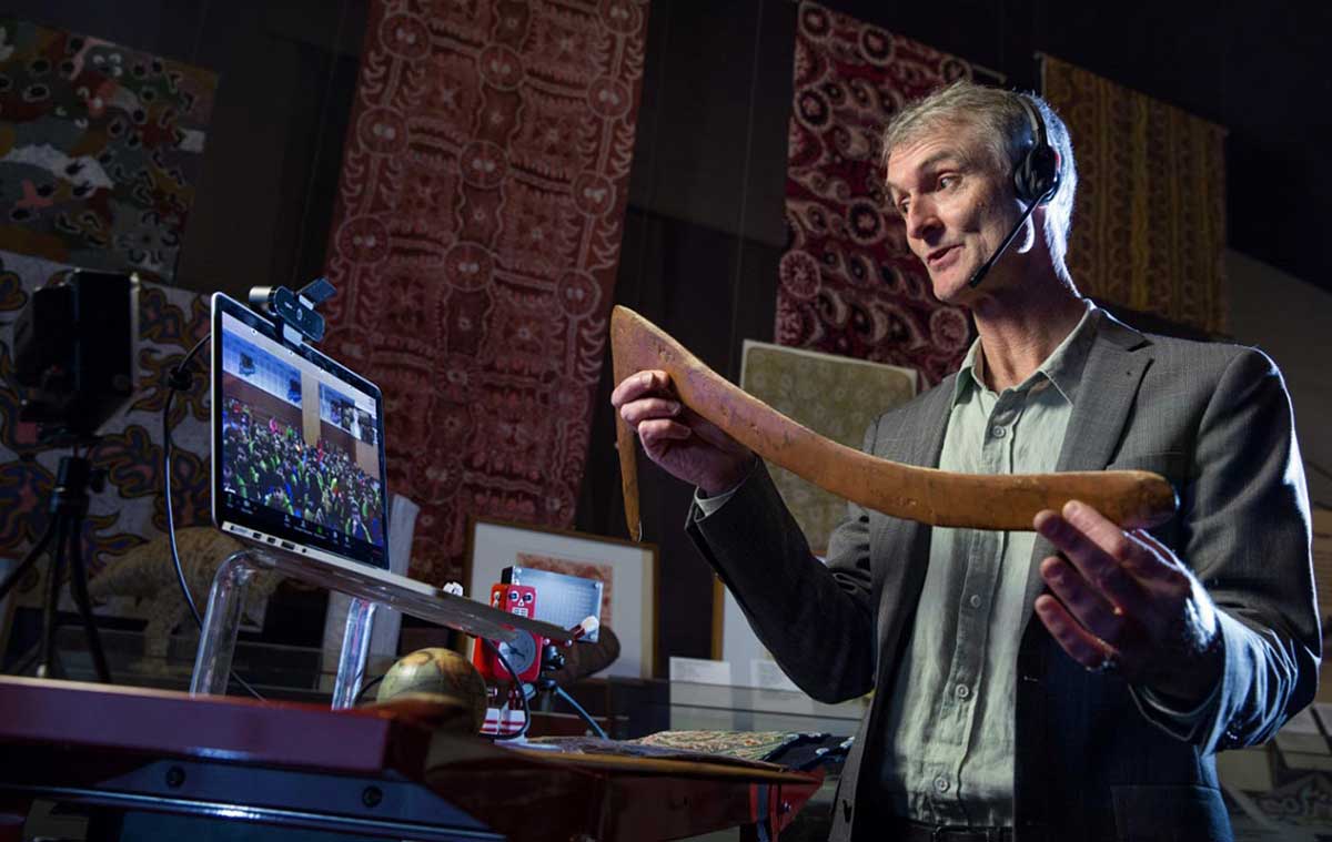 A man is holding a boomerang in a studio with digital equipment. - click to view larger image