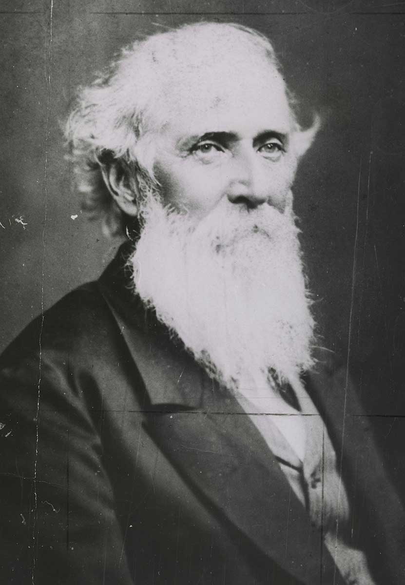 Black and white photo of a portrait of a man with grey hair and a long beard. - click to view larger image