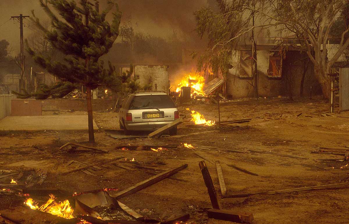 Colour photo of a residential area destroyed by bushfire.