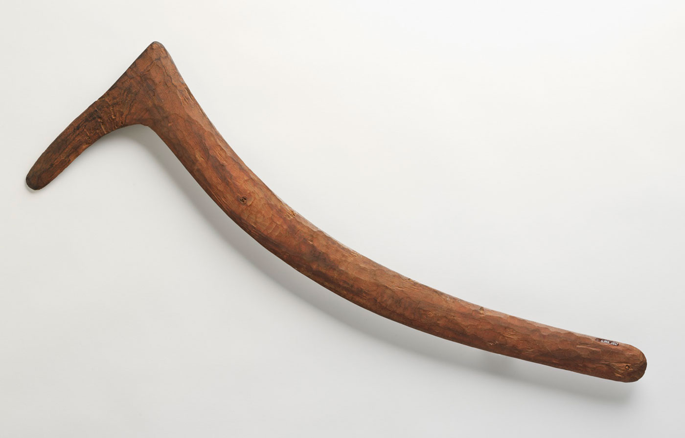 Wooden boomerang with one side about one-quarter as long as the other. - click to view larger image