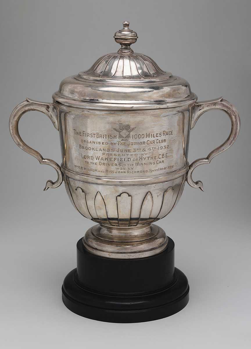 Trophy with a silver lid and cup, and black rounded base. - click to view larger image