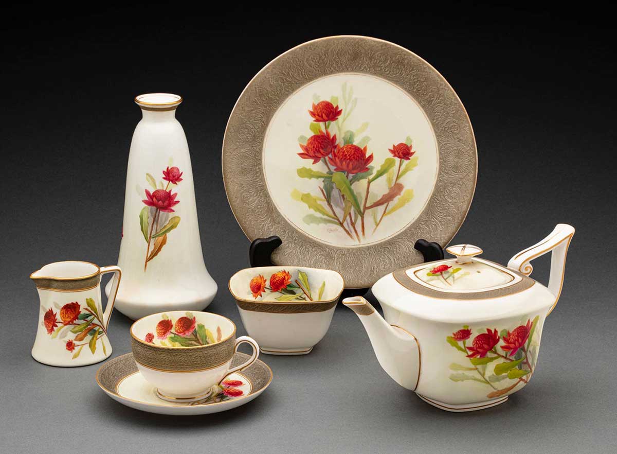 Set of ceramic tableware with detailed embellishments and hand-painted waratahs. - click to view larger image