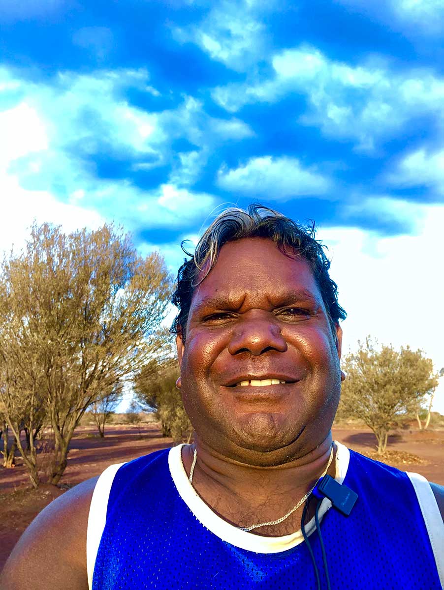 Portrait of a smiling man with the Australian outback in the background. - click to view larger image