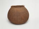 Barrel-shaped basket made of woven coconut leaf ribs, sticks and plant fibre.