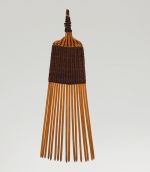 A comb made of seventeen small sticks woven together with a 4cm long weave made of light brown and black fibres.