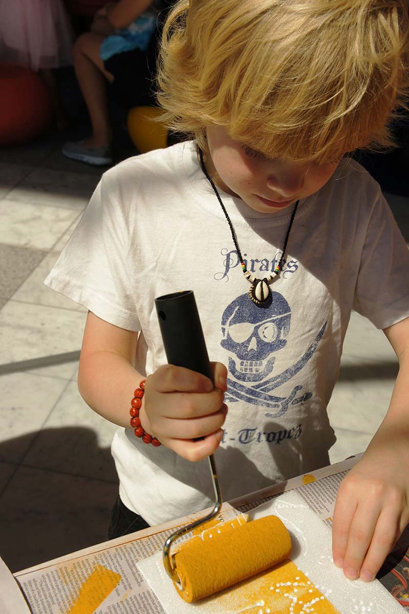 A young visitor busily creating his own artwork in the Old Masters Discovery Space.
