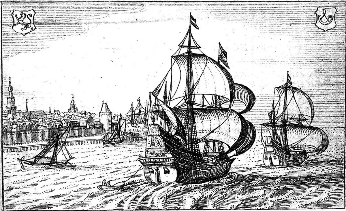 Two Dutch East Indiamen at sea with a walled town on their port side.